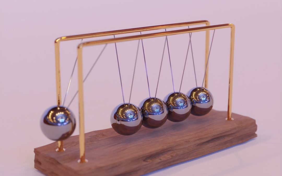 a wooden stand with three metal balls on it